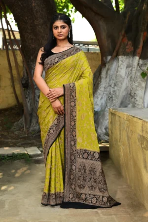 Olive green Banarasi silk saree handwoven with gold zari flower jaal and black border from Golden Muslin by Naaritva Banaras