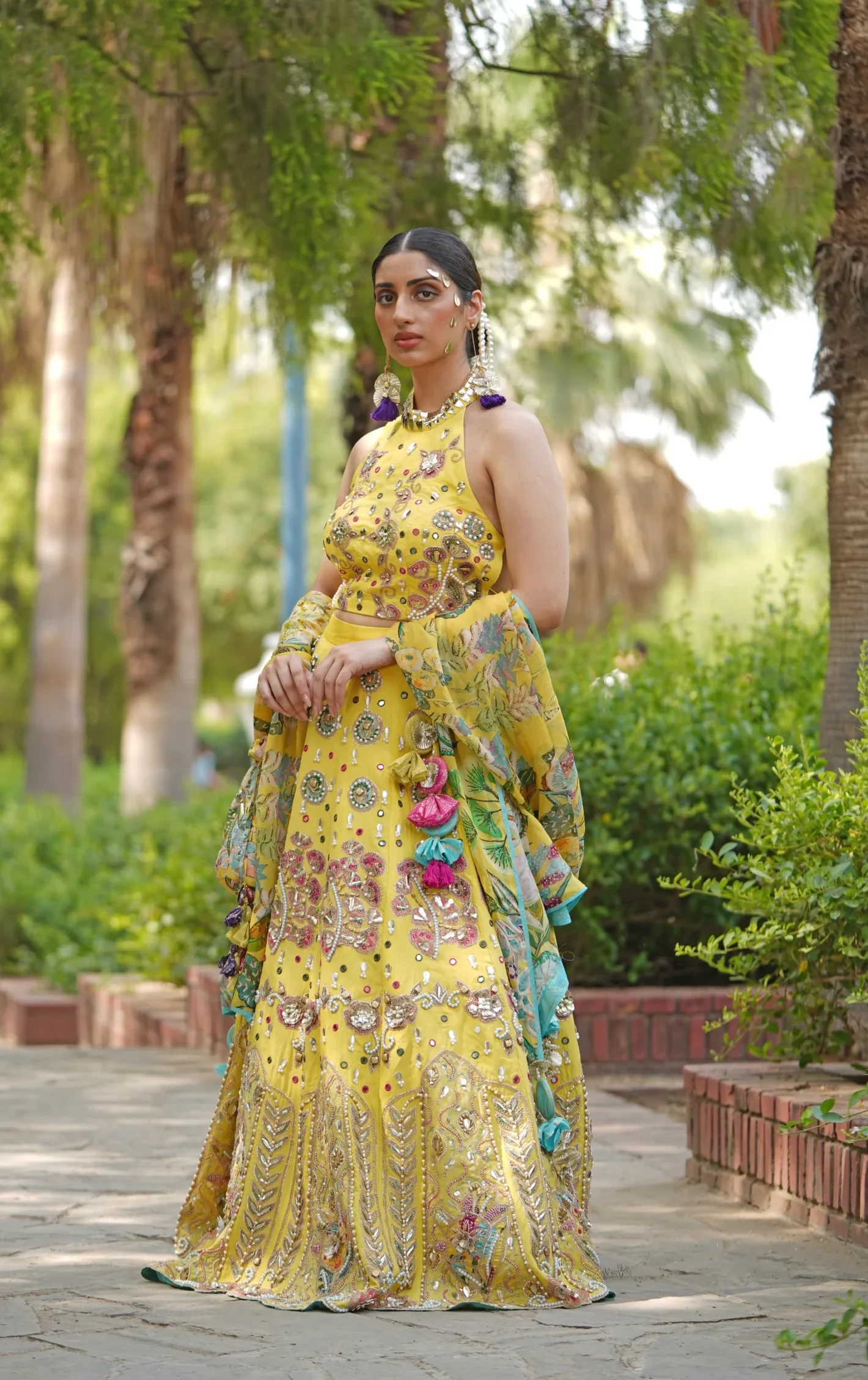 Yellow embroidered lehenga with halter blouse and dupatta from Golden Muslin By Soniya G