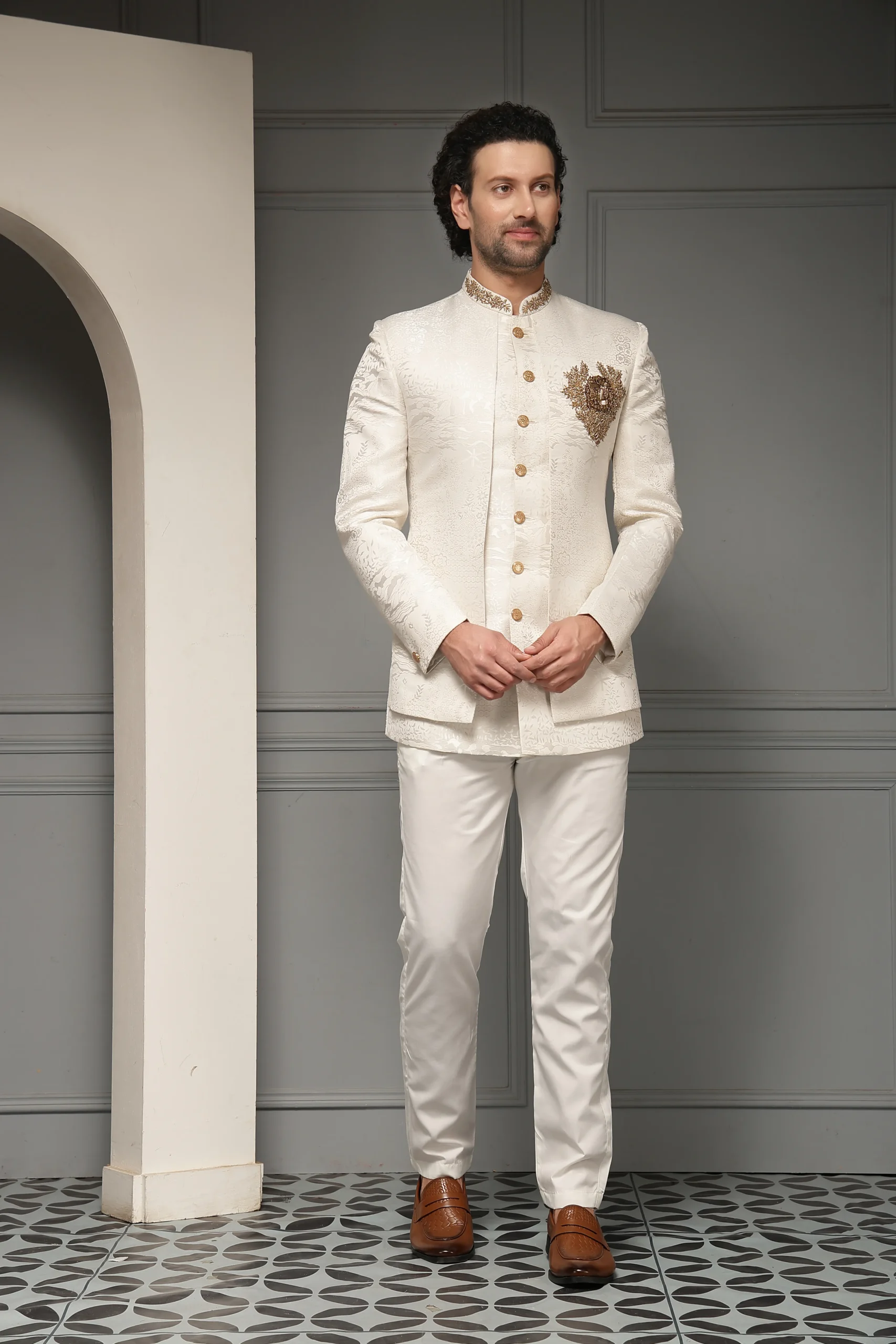 Ivory Jacquard Bandhgala Set with Antique Gold Crest Motif from Golden Muslin By Soniya G featuring zari embroidery and tailored trousers