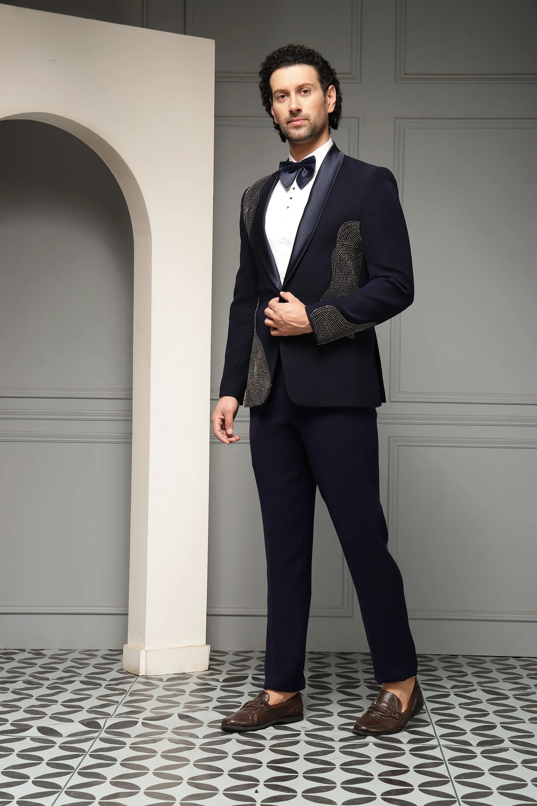 Midnight blue embellished tuxedo blazer with satin shawl lapel and matching trousers from Golden Muslin By Soniya G