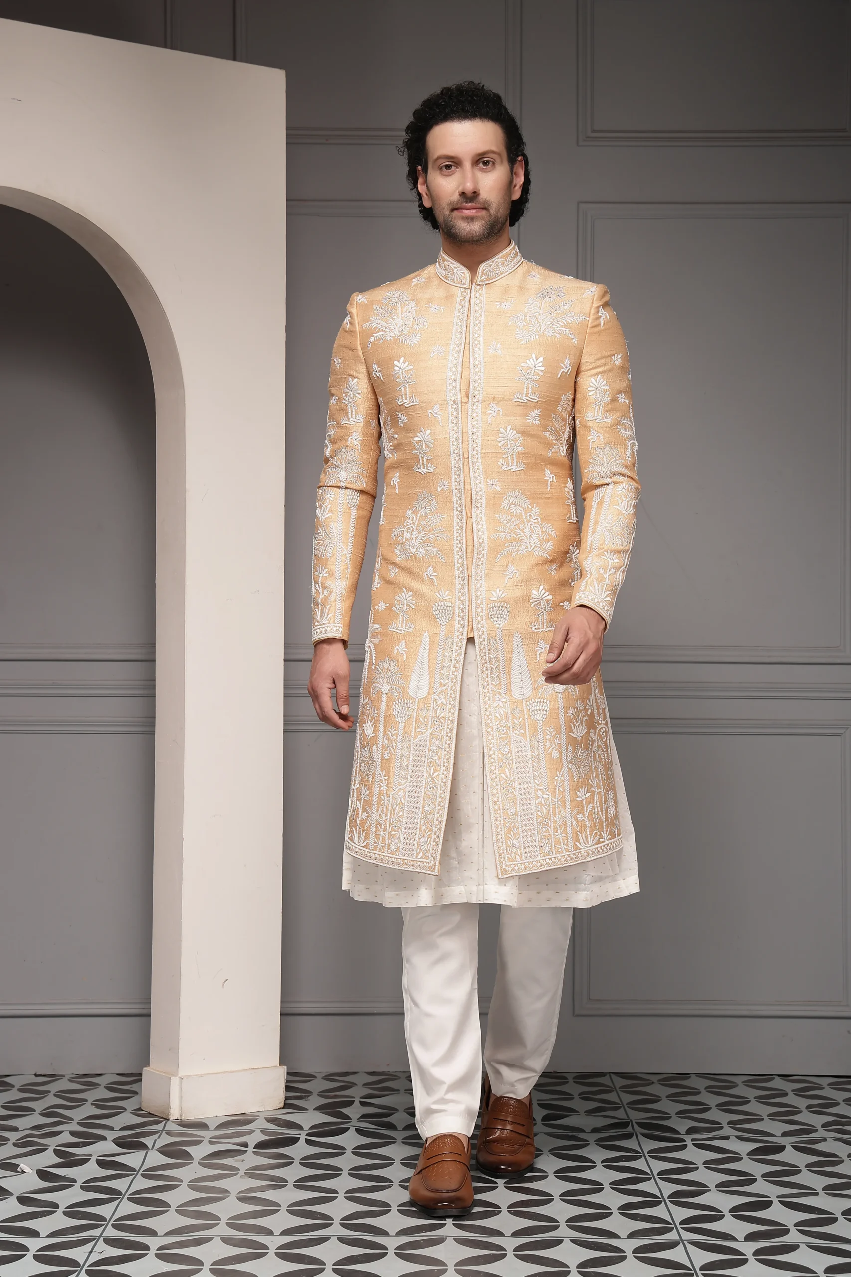Peach silk-blend sherwani with ivory embroidery and matching kurta trousers from Golden Muslin By Soniya G