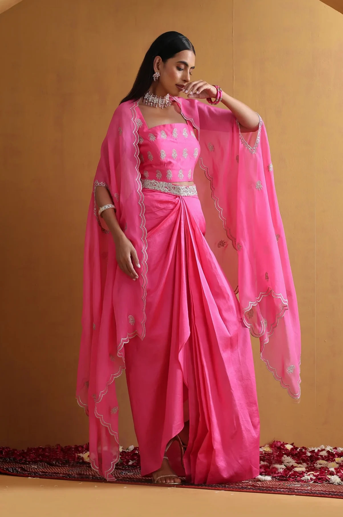 Radiant pink draped embroidered ensemble with cape sleeves from Golden Muslin By Suikala