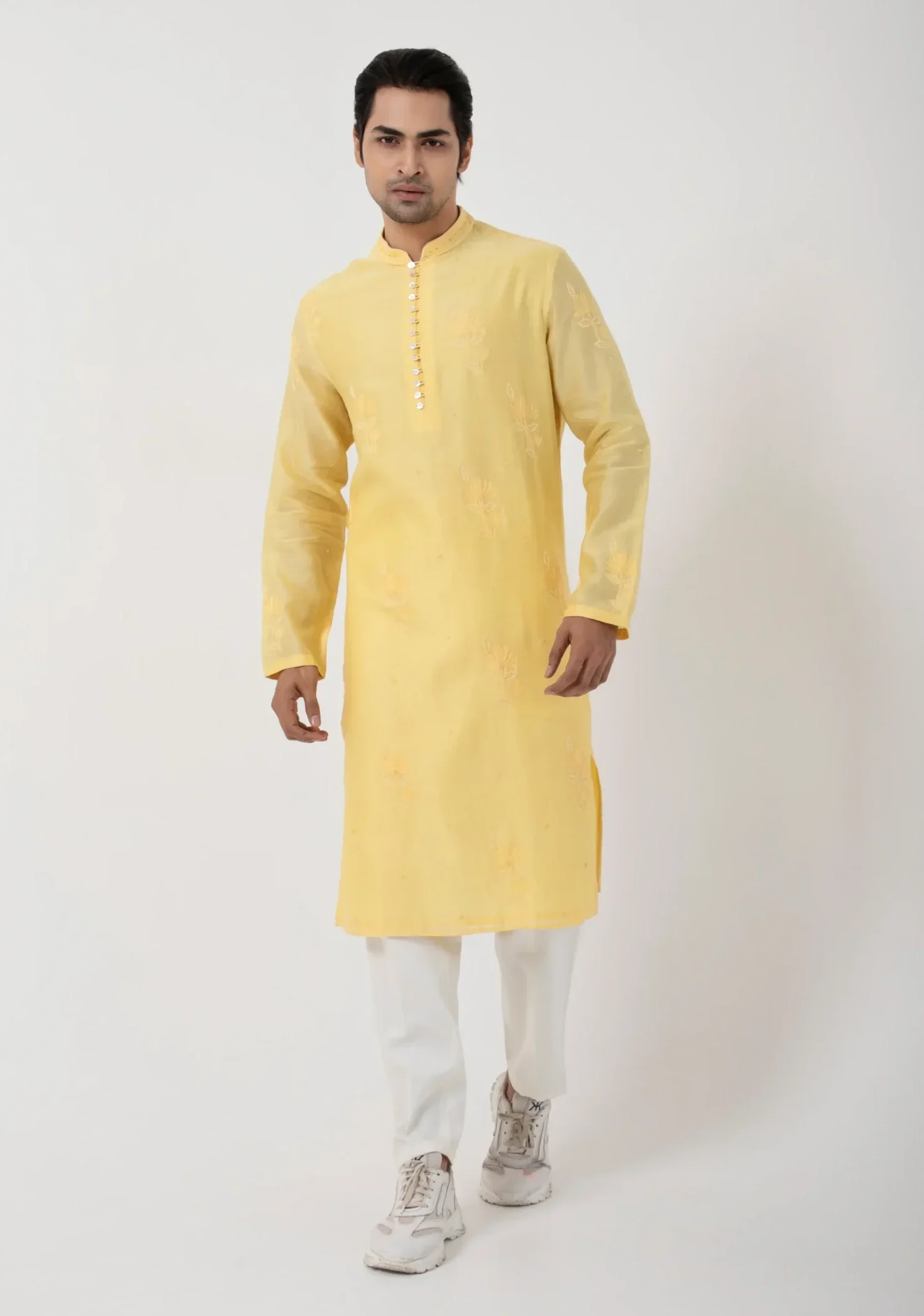 Model wearing butter yellow golden muslin kurta set for men with ivory pant pajama