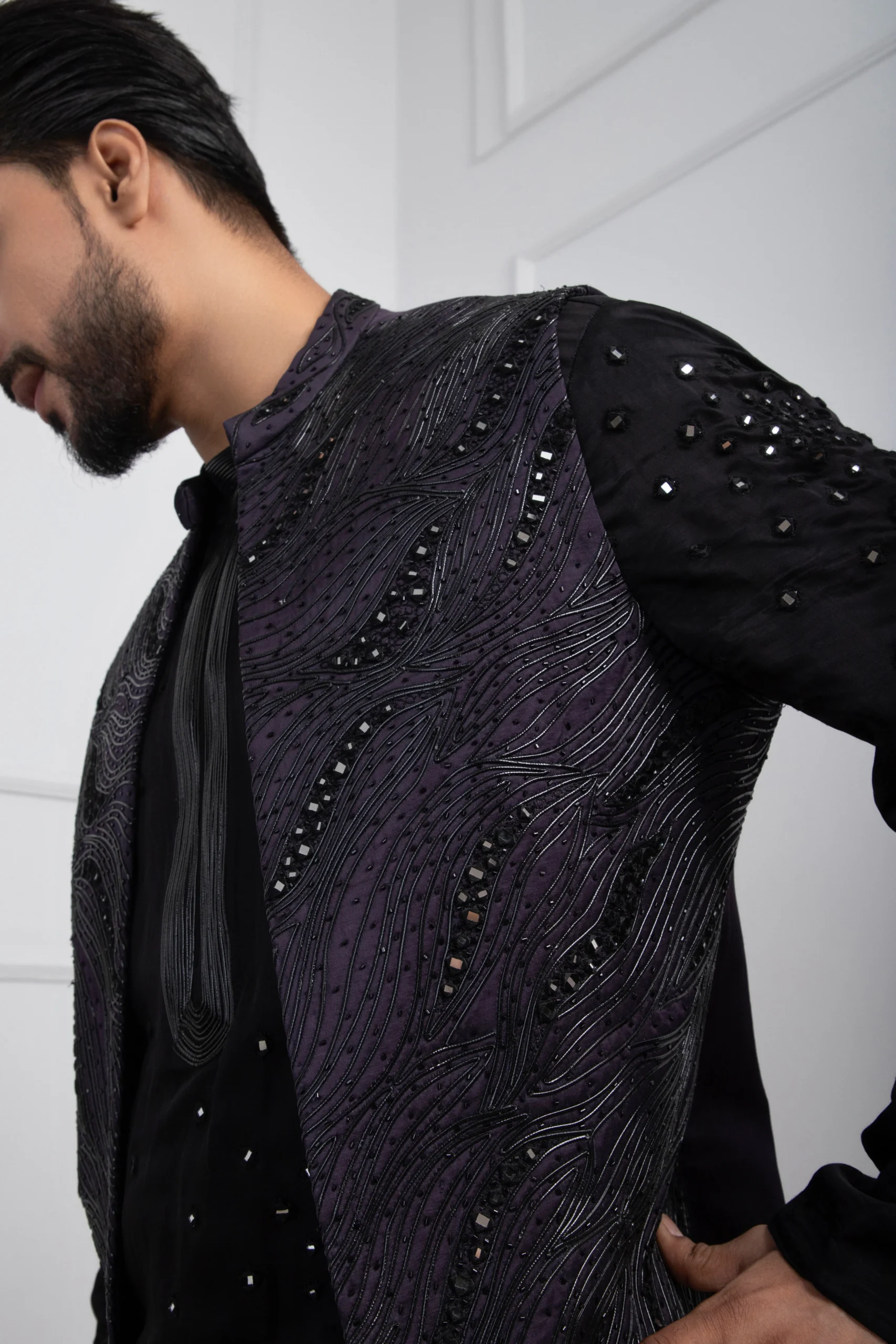 Model wearing dark purple golden muslin abstract Nehru jacket with beadwork and sequins