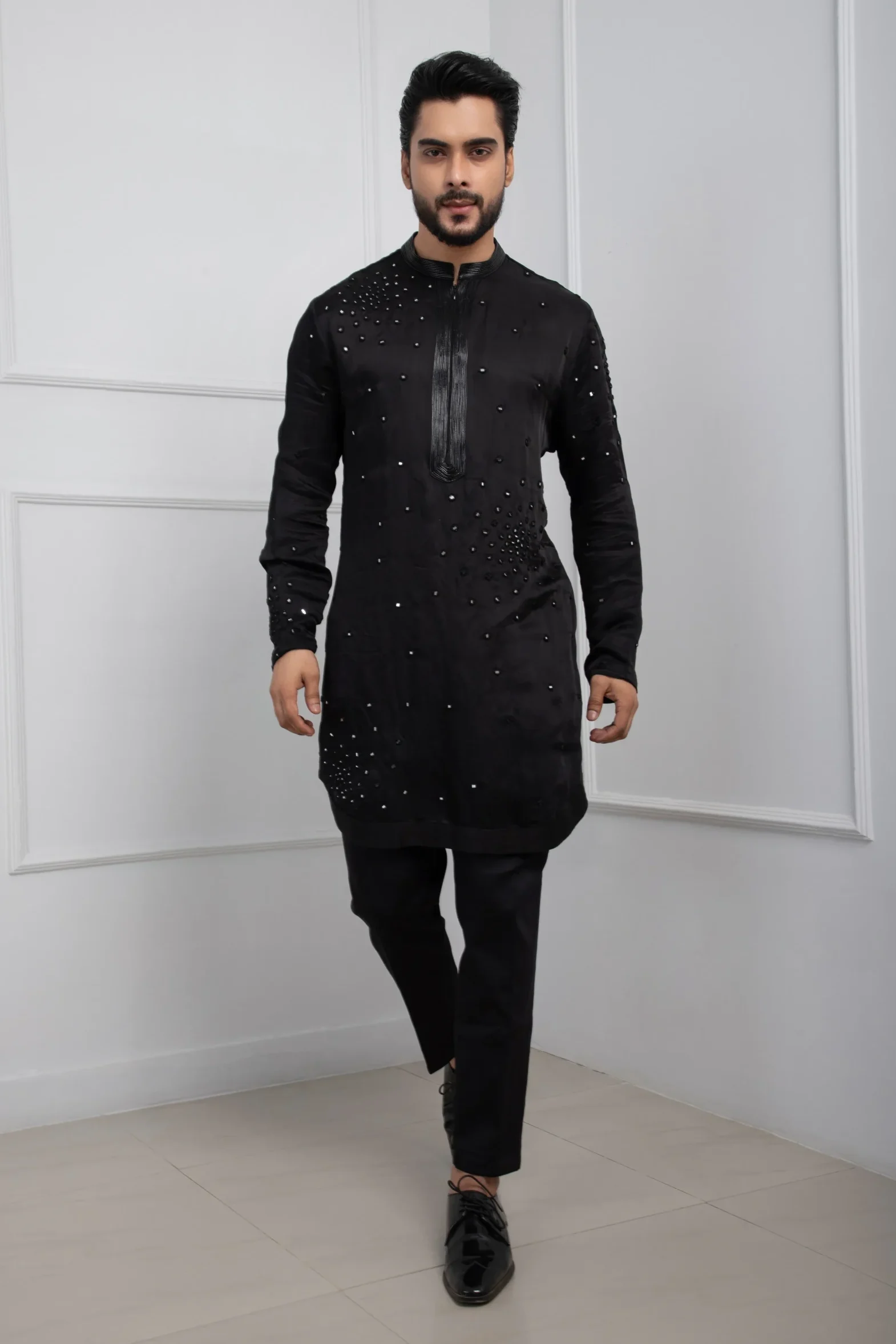 Model wearing black obsidian golden muslin zipper kurta set with intricate mirrorwork
