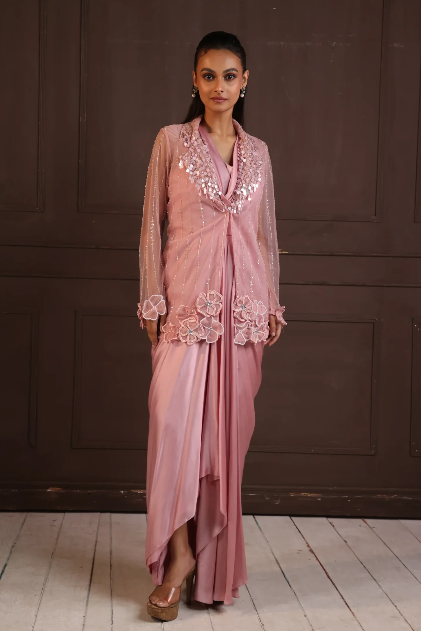 Model wearing blush pink golden muslin modal silk gown with embroidered organza jacket