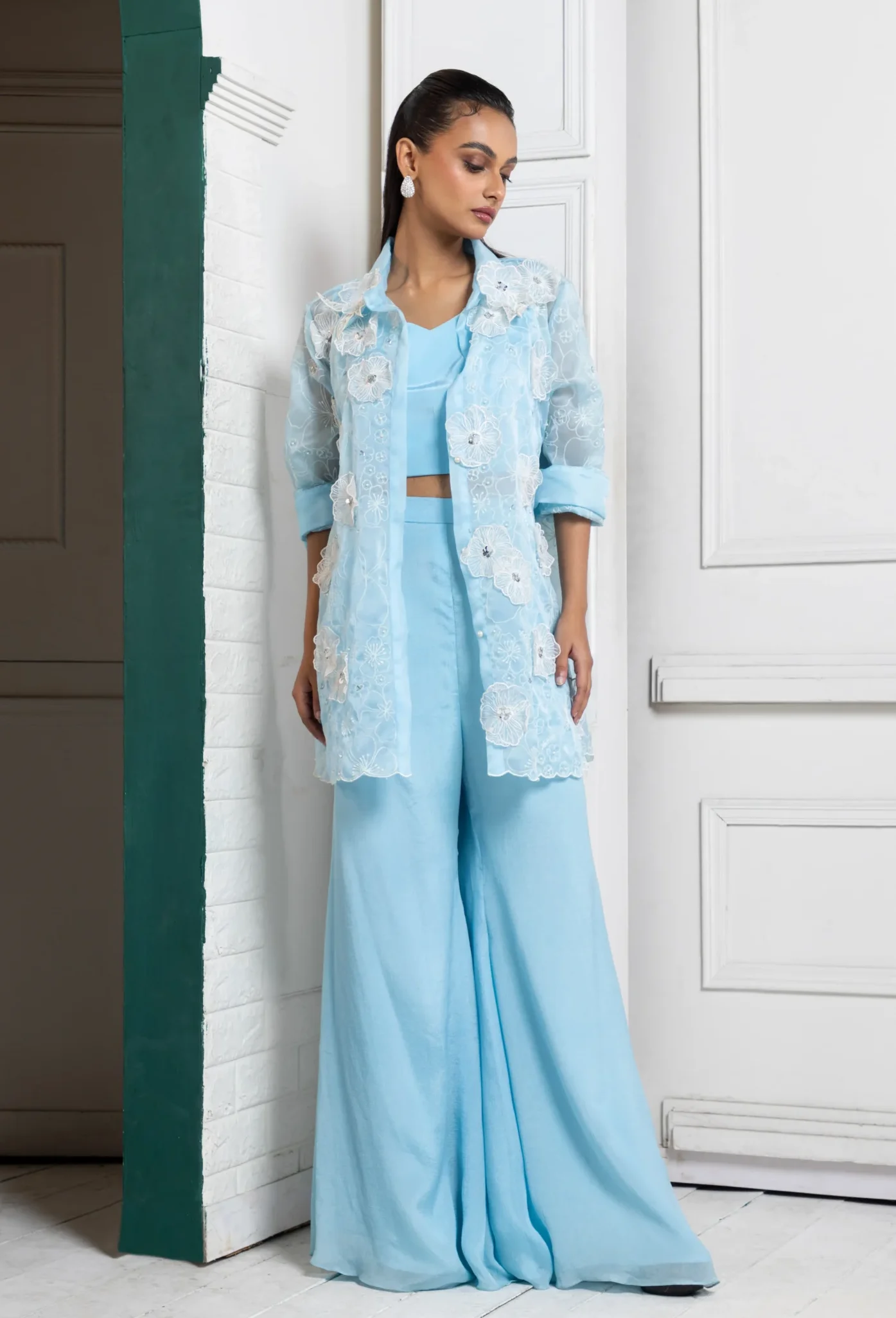 Model wearing powder blue golden muslin embroidered co ord set with sheer jacket and palazzo pants