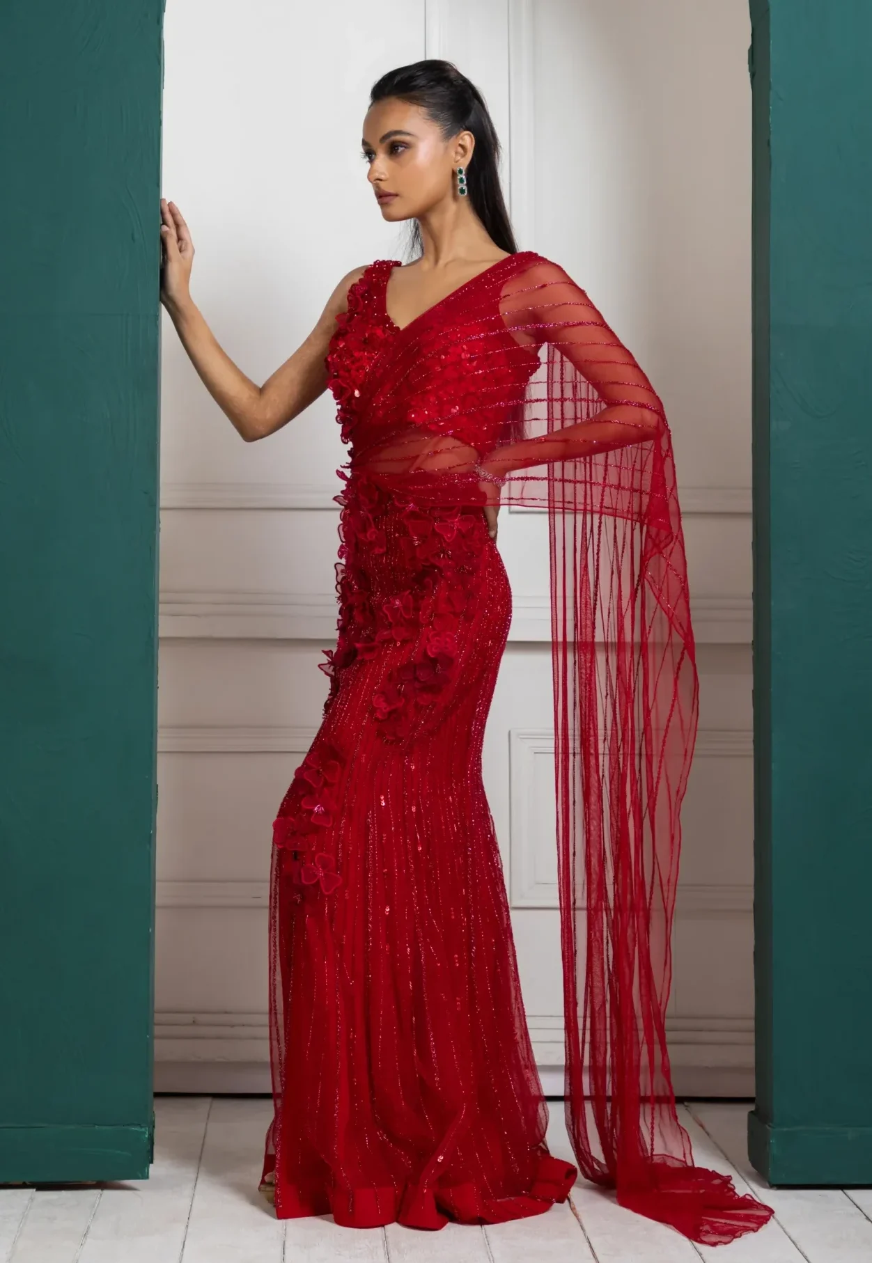 Model wearing red golden muslin embellished pre-stitched drape saree set with floral appliqué blouse