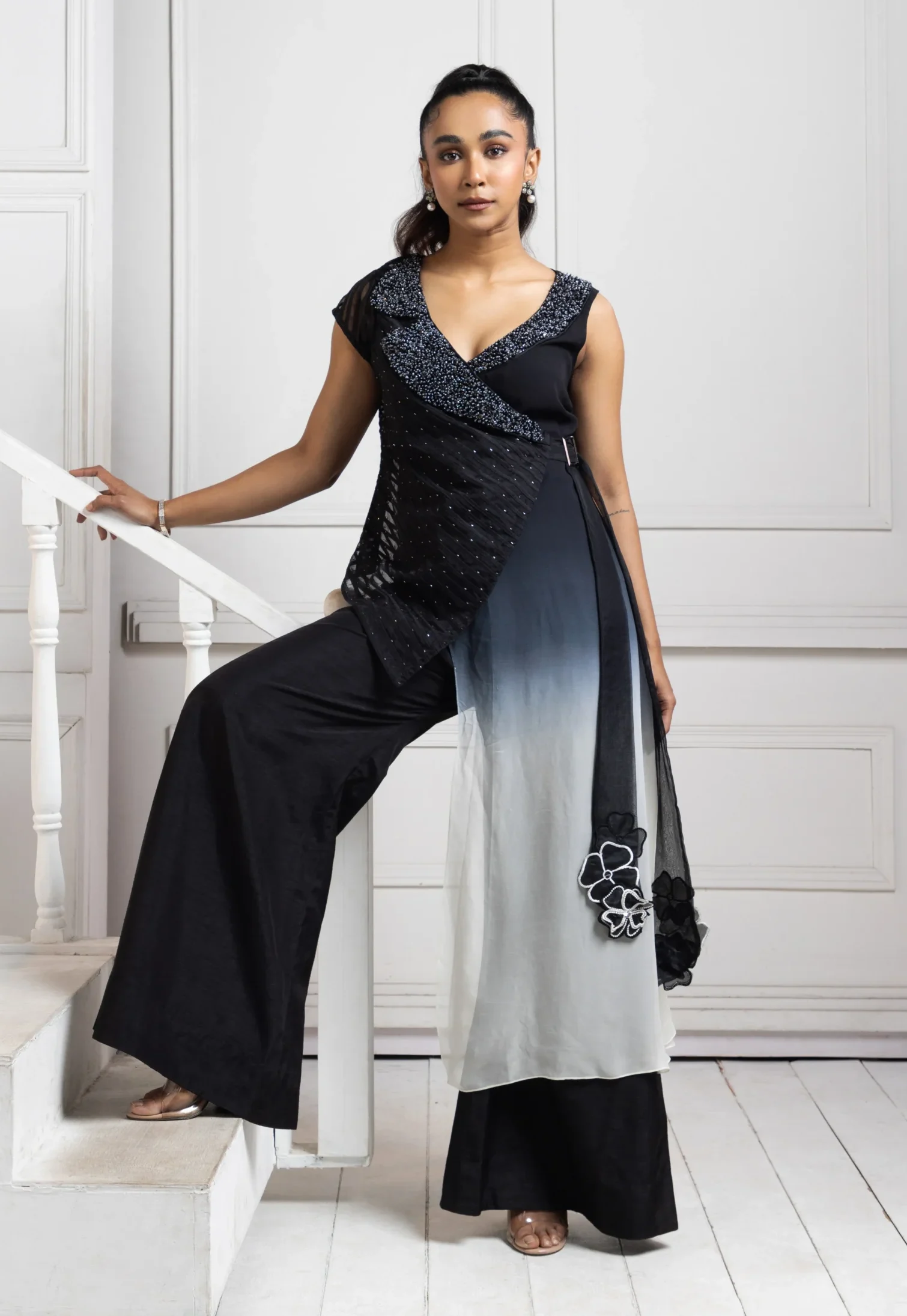 Black ombre draped jumpsuit with floral hand embroidery and wide-leg trousers from Golden Muslin By Anuj Agarwal
