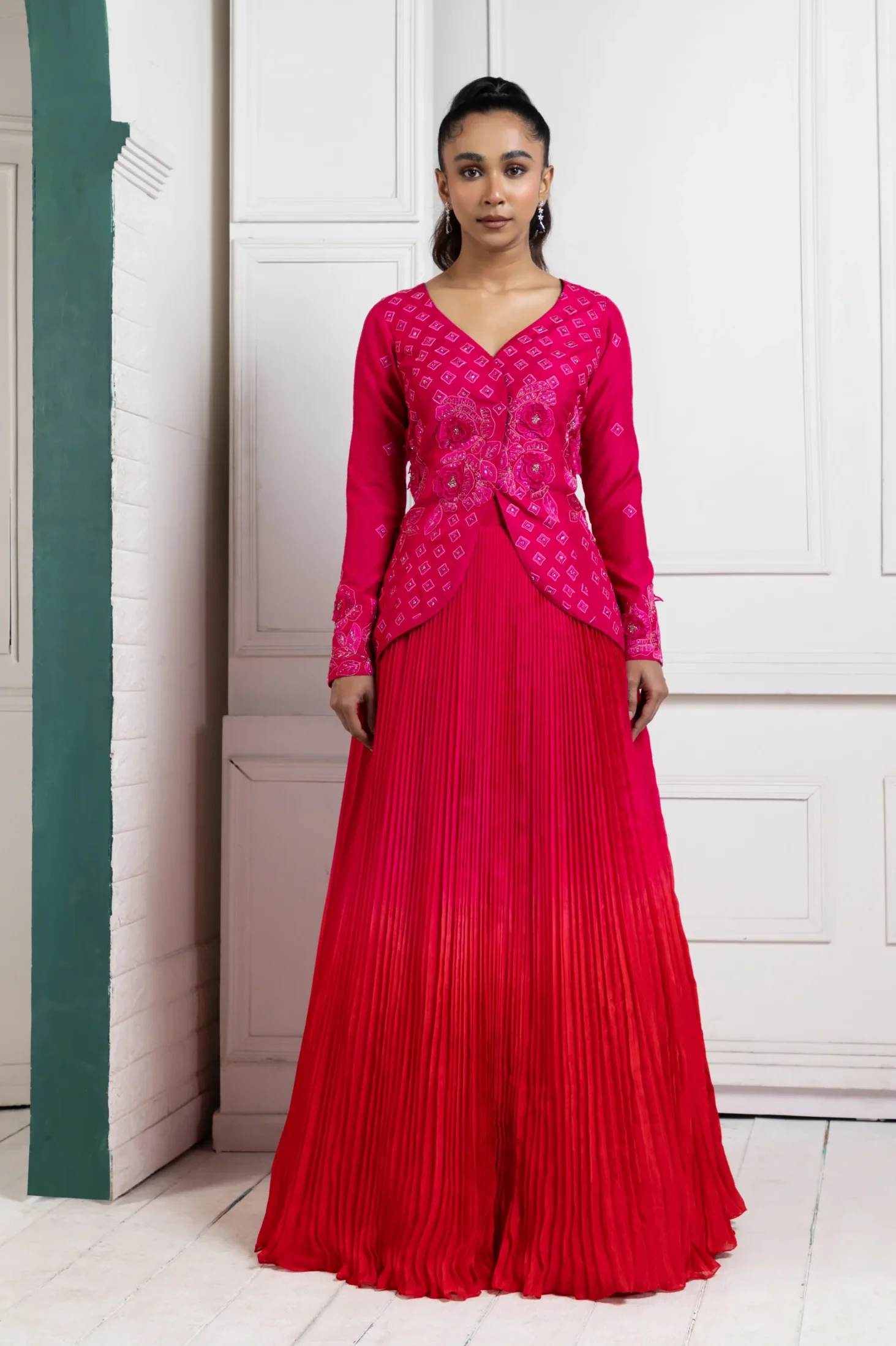 Model wearing crimson grace golden muslin embroidered lehenga set with pleated skirt and long sleeve blouse