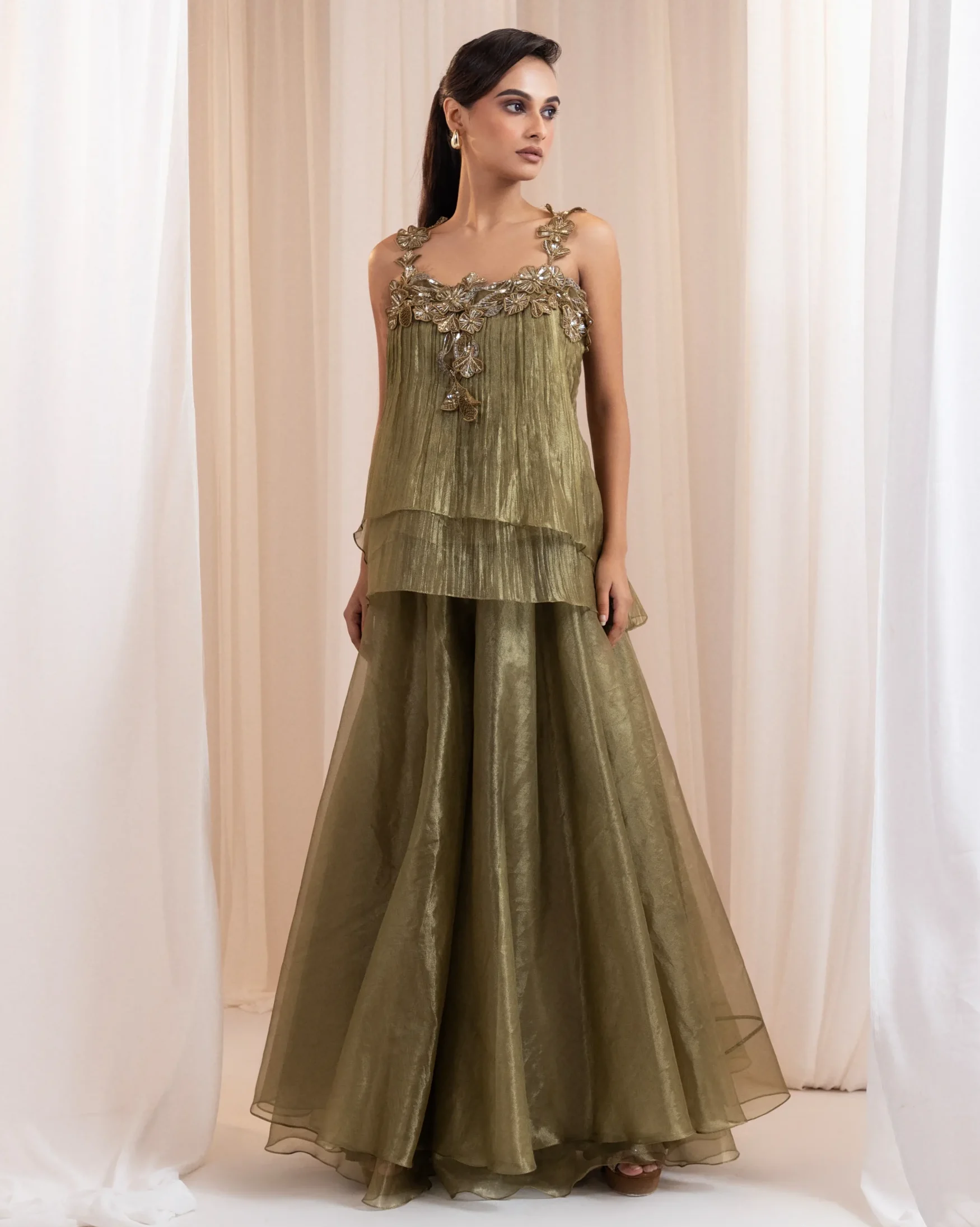 Antique olive green peplum top with 3D floral appliqués and flared pants from Golden Muslin By Anuj Agarwal