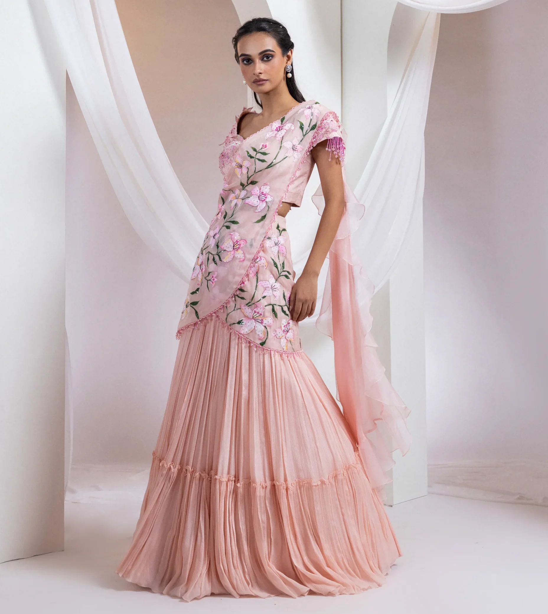 Baby pink hand-painted ruffle saree with embroidered floral blouse from Golden Muslin By Anuj Agarwal