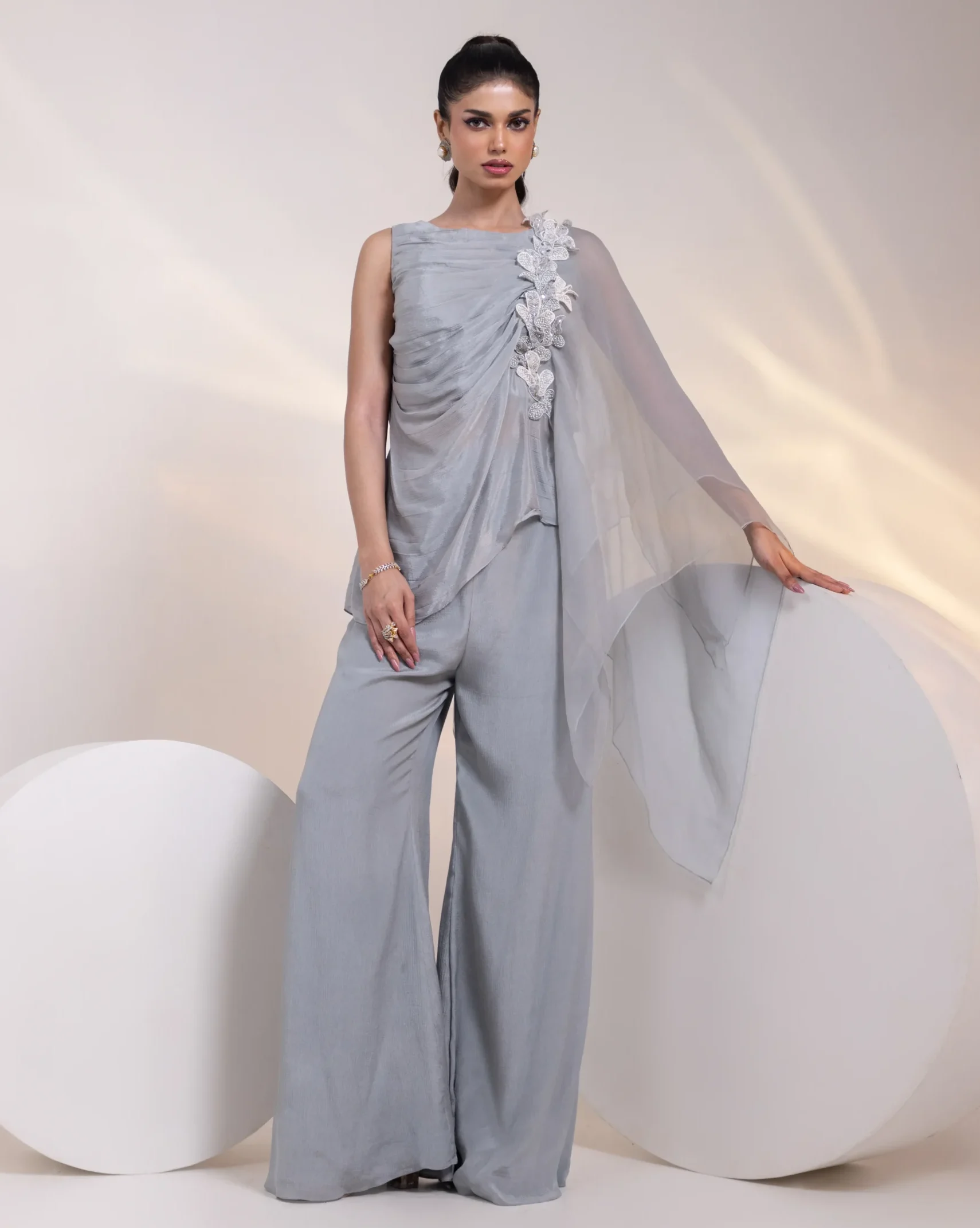 Ash Grey Embroidered Sleeveless Tunic with Organza Shoulder Drape and Wide-Leg Trousers from Golden Muslin By Anuj Agarwal