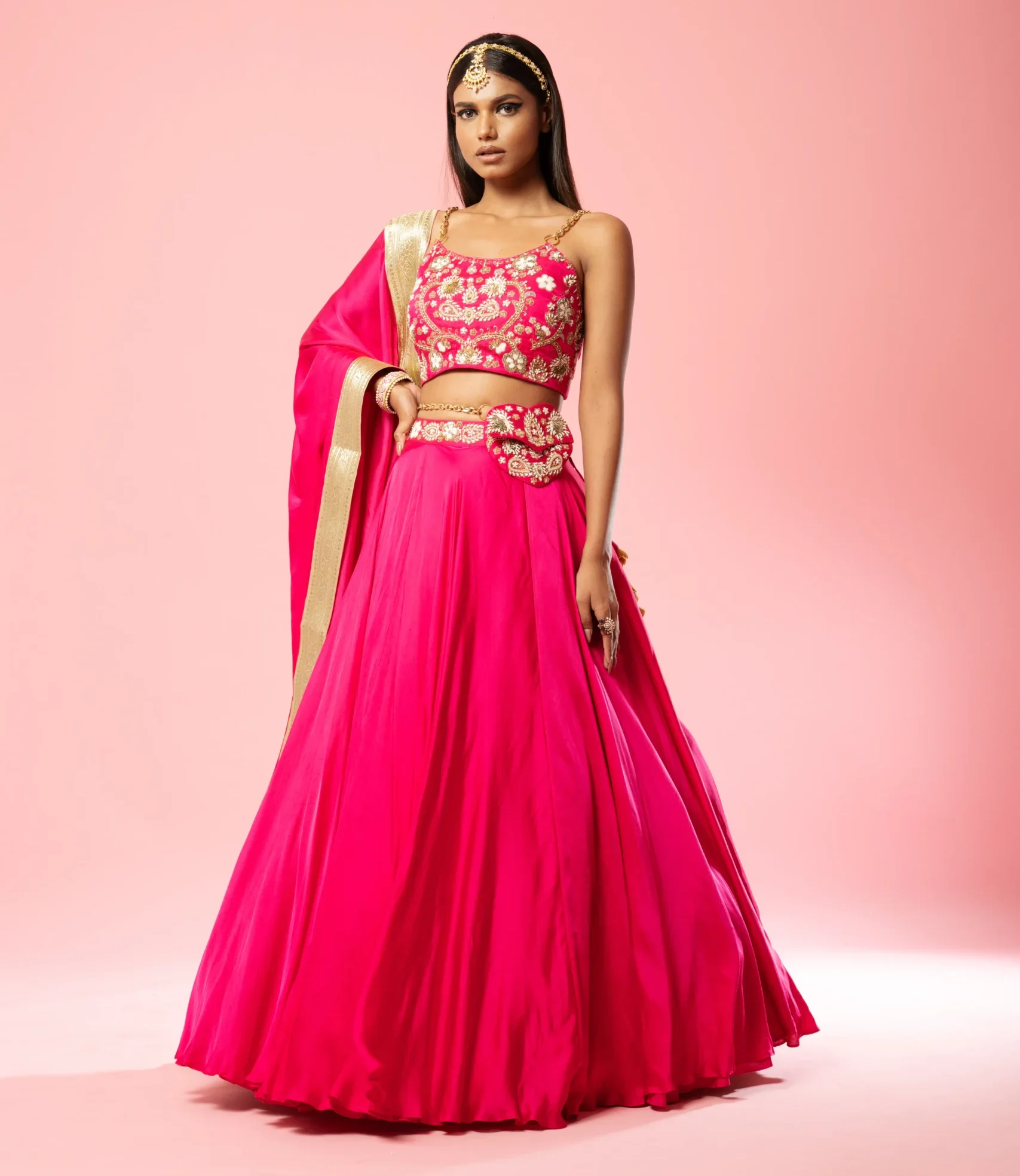 Hot Pink Modal Satin Lehenga Set with Hand Embroidery and Metal Sleeves from Golden Muslin By Quench A Thirst