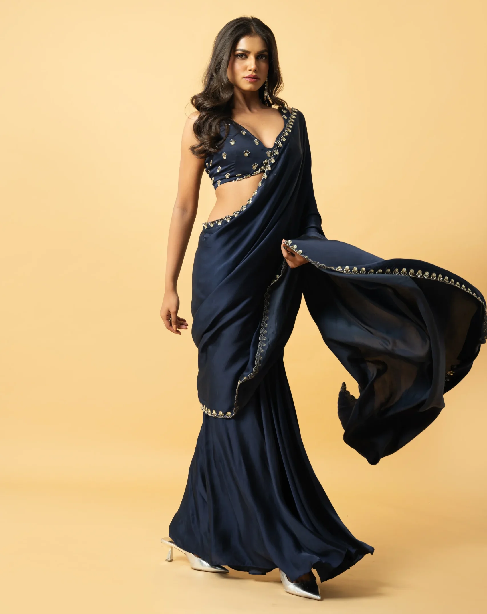 Blue Modal Satin Pre-Draped Saree with hand-embroidered sleeveless blouse featuring mirror work and zari from Golden Muslin By Quench A Thirst