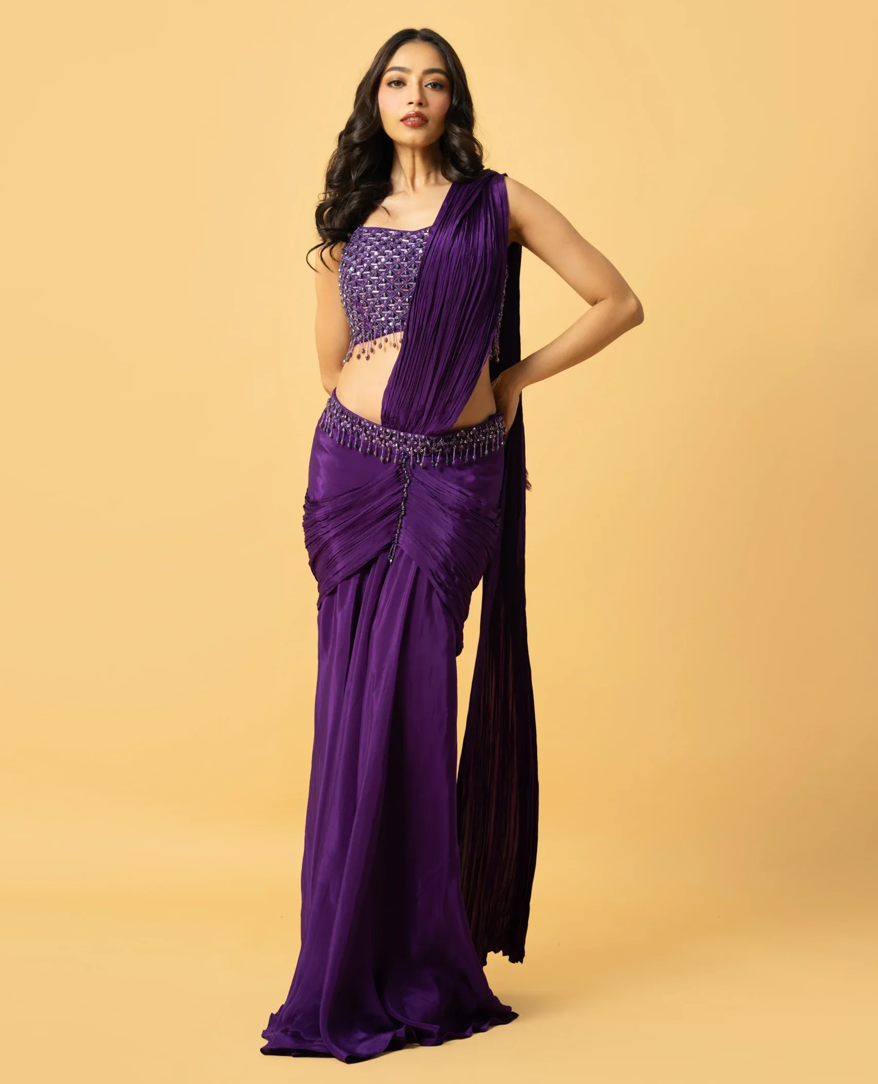 Violet Crepe Pre-Draped Saree with hand-embroidered sleeveless blouse featuring crystal and tiki work from Golden Muslin By Quench A Thirst