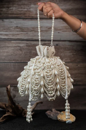 Ivory Pearl Embellished Velvet Potli Bag with Layered Pearls and Tassel Detail